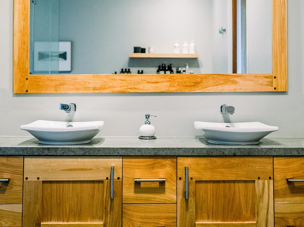 Bathroom with sinks, mirror and closets